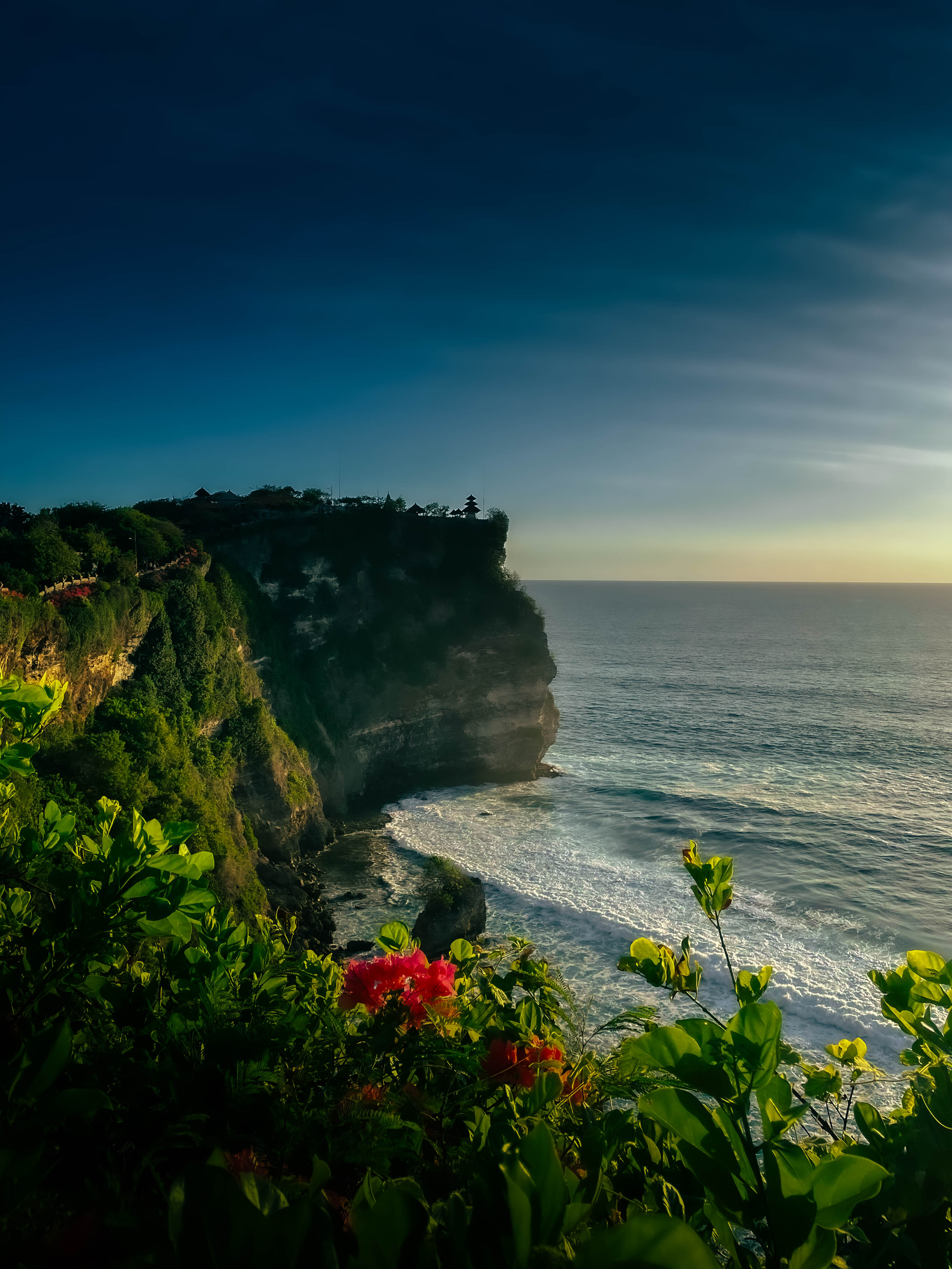 Uluwatu Temple cliffside with ocean views at noon